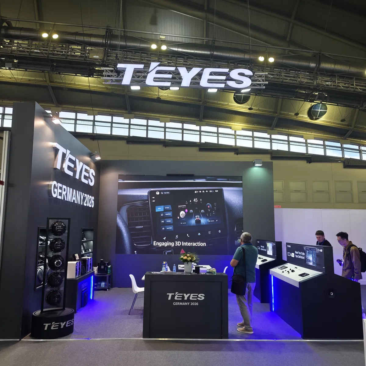 TEYES booth panorama at Automechanika Frankfurt 2026 — hanging illuminated TEYES logo, 3D interaction screen, speaker driver tower and CC4 display islands